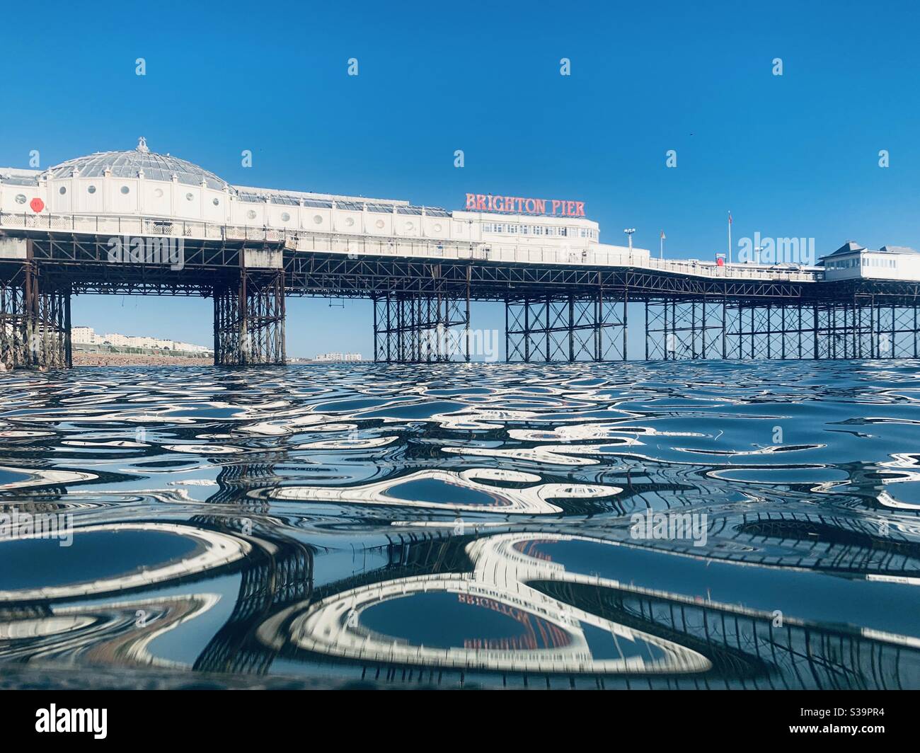 View across the water towards Brighton pier Stock Photo