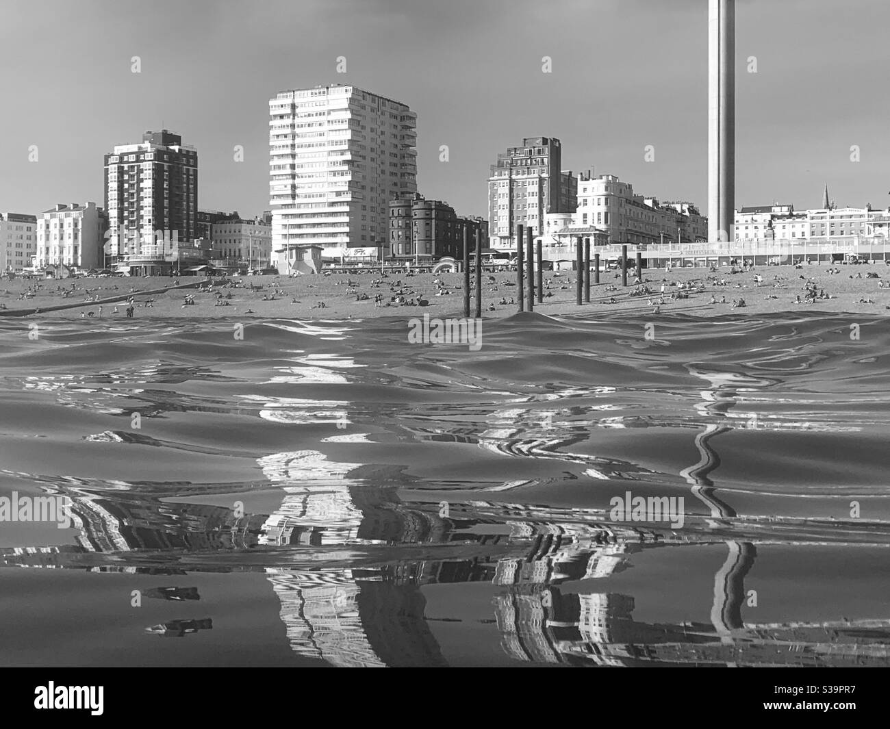 Reflections of buildings in the sea at Brighton beach - Smartphone Captured Stock Image
