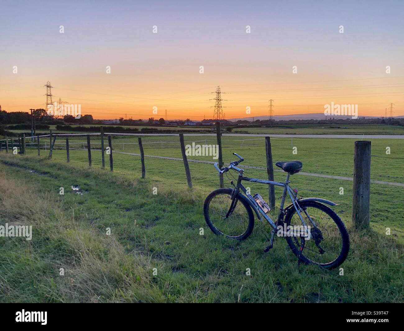 Orange sky at sunset or dusk with bicycle - Smartphone Captured Stock Image