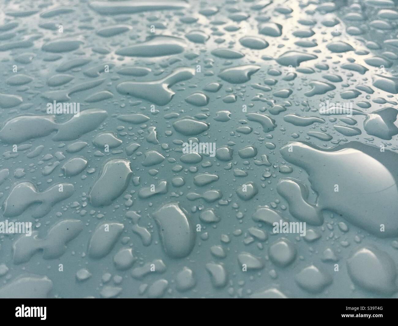 Droplets of rainwater on painted metal - Smartphone Captured Stock Image