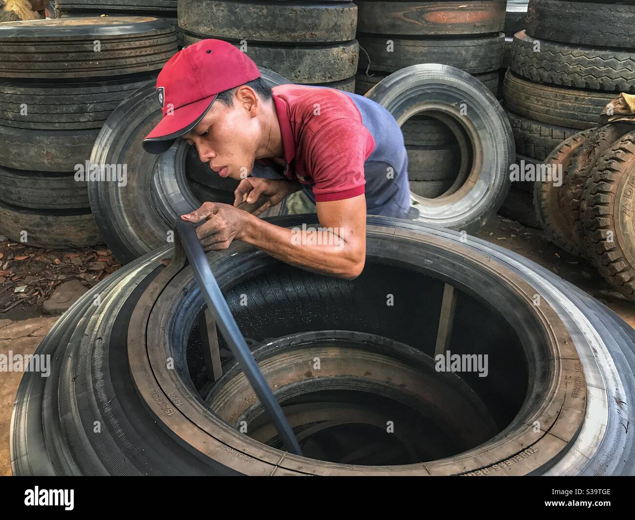 The work of recycling the tires. Stock Photo