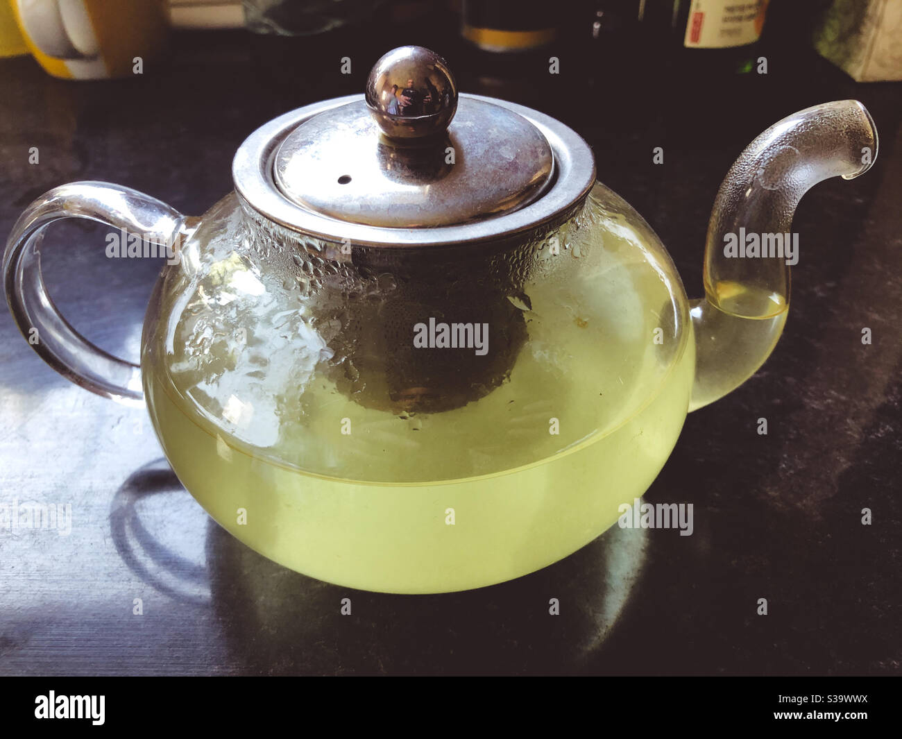Homemade mint tea infusing in a glass teapot. - Smartphone Captured Stock Image