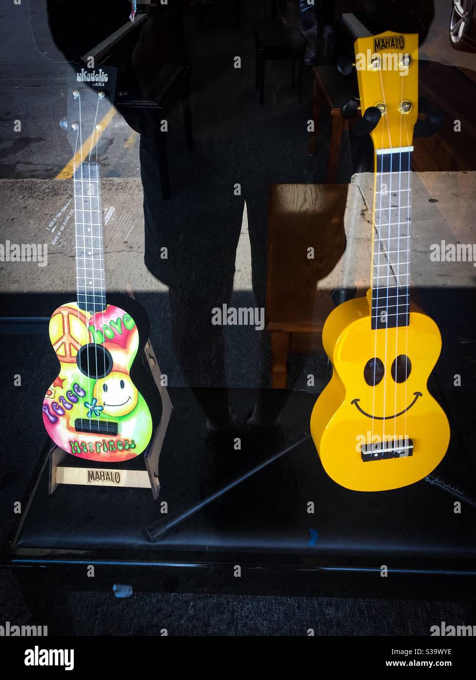 Playful and smiling guitars in a store window Stock Photo