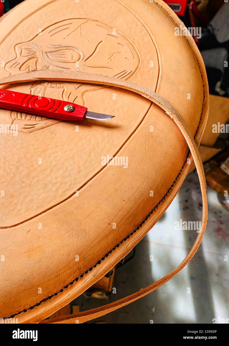 Tooled leather seat being crafted for a custom motorcycle. Stock Photo