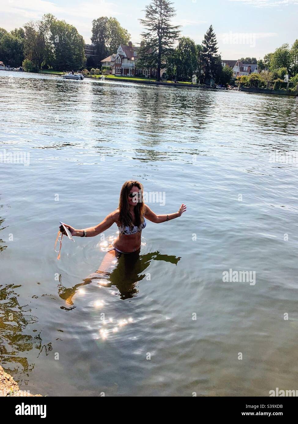 Woman wading in river at Kingston upon Thames - Smartphone Captured Stock Image