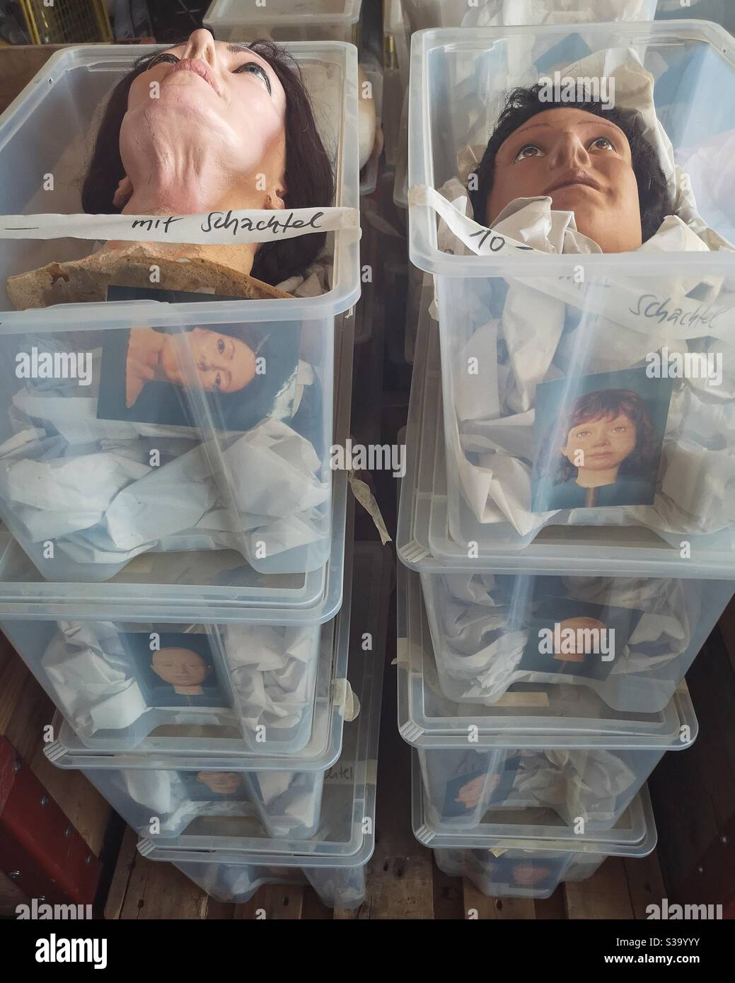 Heads of tailor's dummies stacked in boxes - Smartphone Captured Stock Image