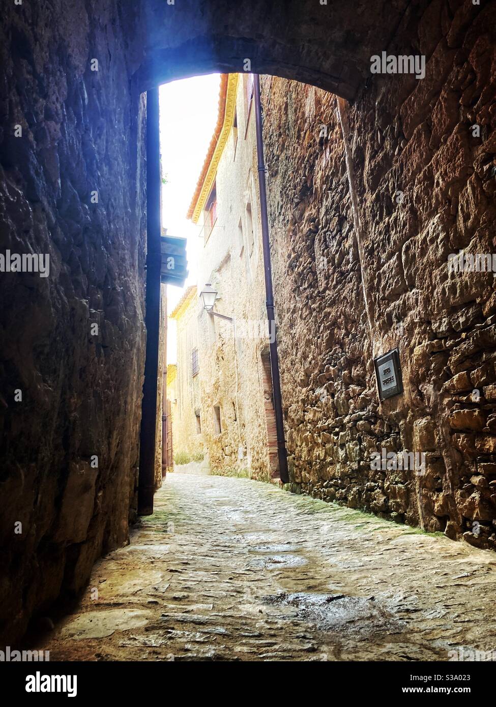 Narrow street in gorgeous medieval hilltop walled village of Pals, Baix Empordà, Girona, Catalonia, Spain - Smartphone Captured Stock Image
