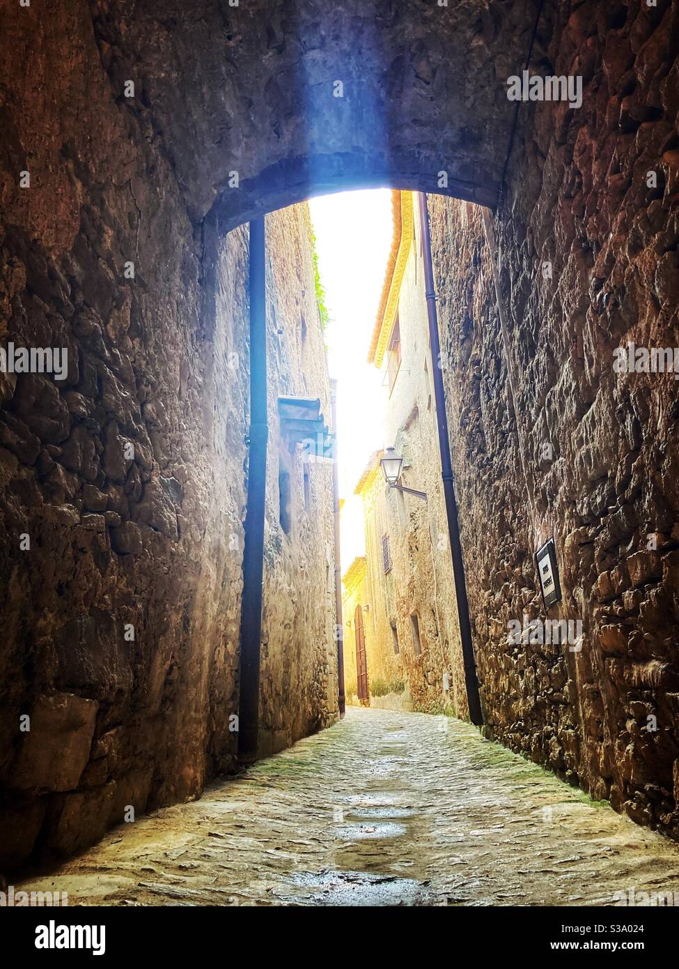 Narrow street in gorgeous medieval hilltop walled village of Pals, Baix Empordà, Girona, Catalonia, Spain - Smartphone Captured Stock Image