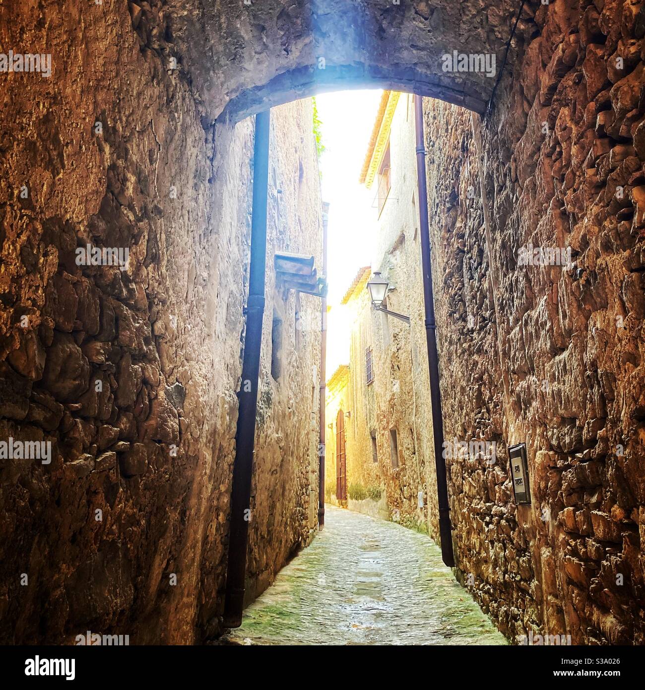 Narrow street in gorgeous medieval hilltop walled village of Pals, Baix Empordà, Girona, Catalonia, Spain - Smartphone Captured Stock Image