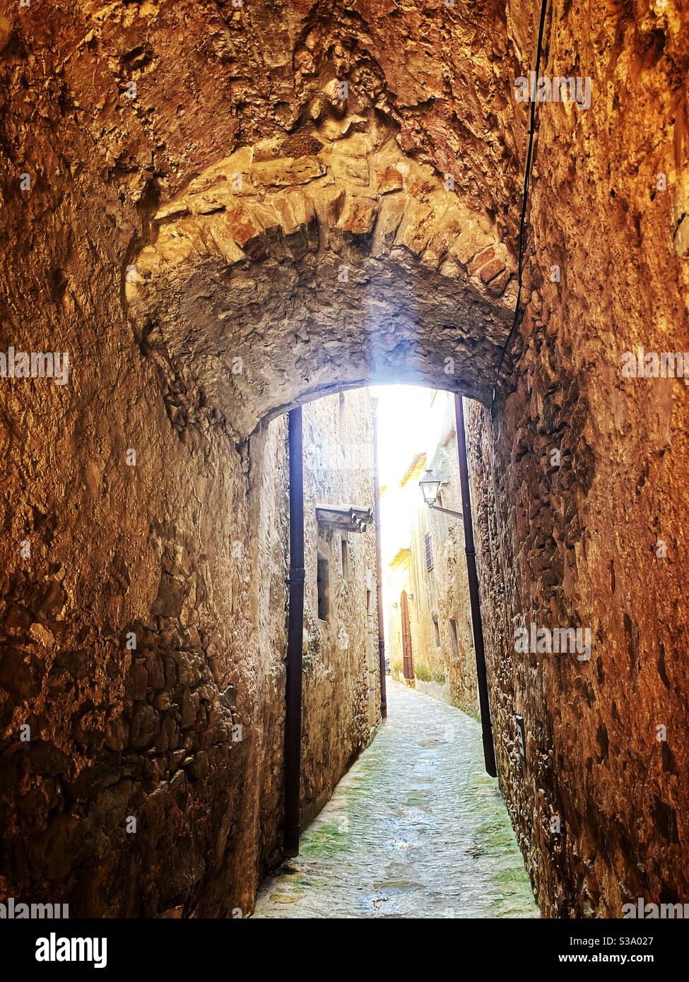 Narrow street in gorgeous medieval hilltop walled village of Pals, Baix Empordà, Girona, Catalonia, Spain - Smartphone Captured Stock Image