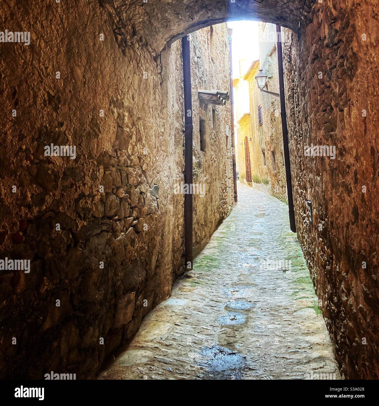 Narrow street in gorgeous medieval hilltop walled village of Pals, Baix Empordà, Girona, Catalonia, Spain - Smartphone Captured Stock Image