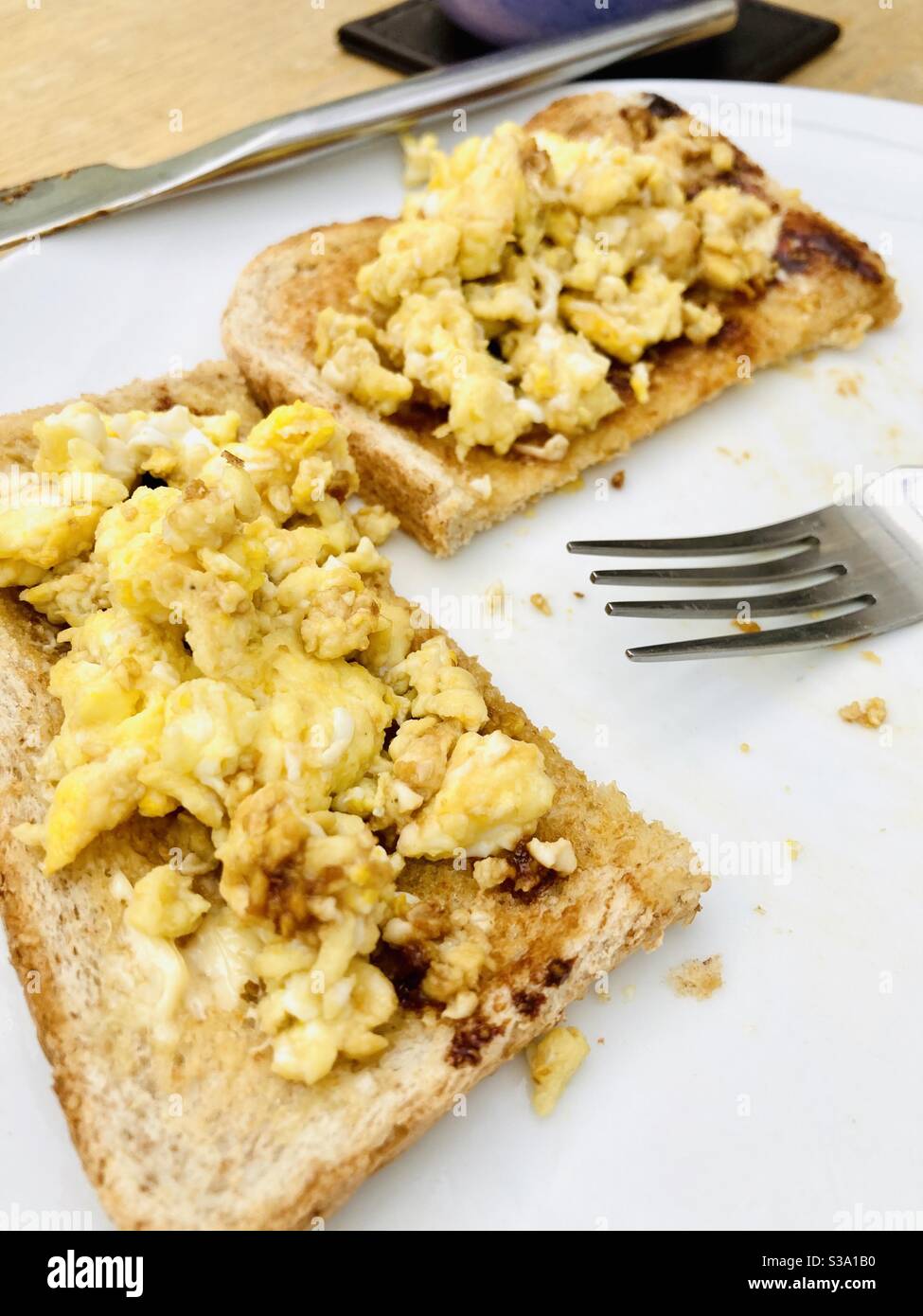 Eating Scrambled eggs on toast Stock Photo Alamy