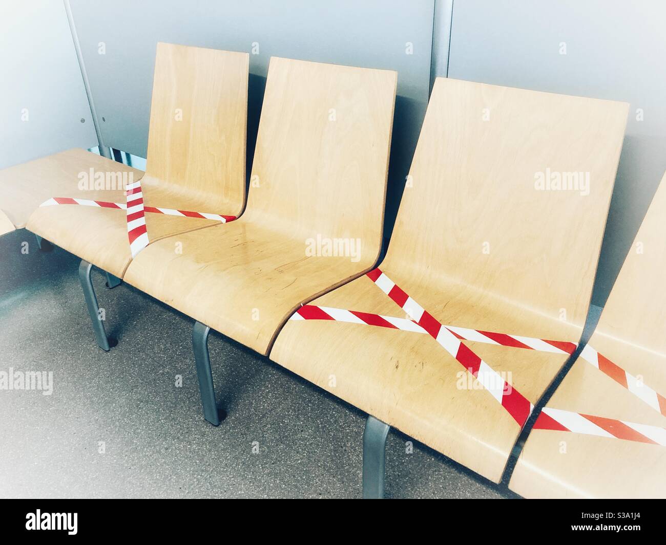 Empty seats at public area with a warning to keep the social distance during the COVID-19 pandemic Stock Photo