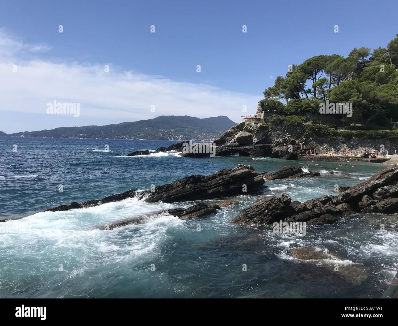 Water splashing against the rocks in Zoagli on the Italian Riviera coastline - Smartphone Captured Stock Image