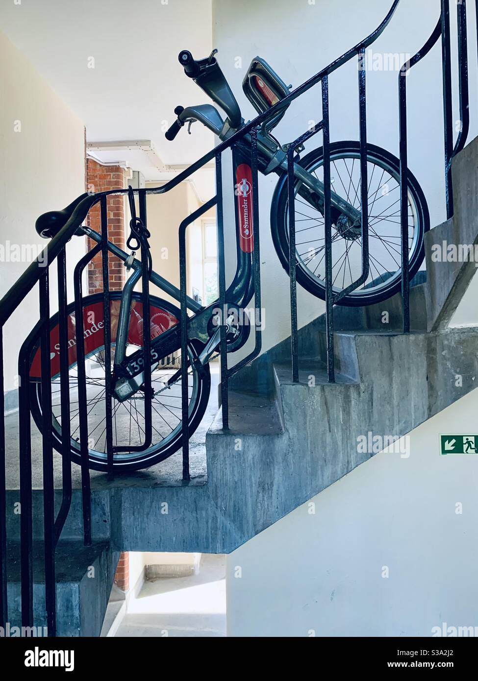 Boris bike locked to railings in council block - Smartphone Captured Stock Image