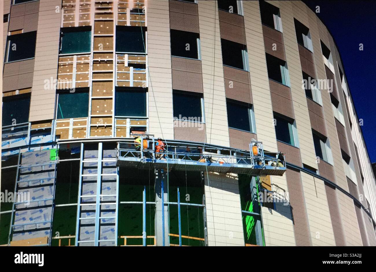 Alberta Bound, Window washing, sky scraper, office building,  construction, crane. Calgary, Alberta Stock Photo