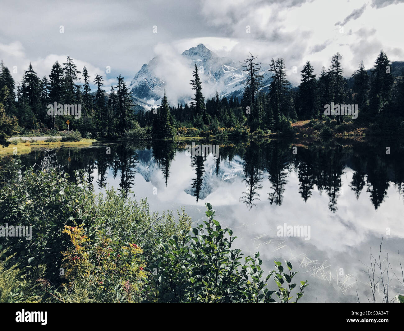 Mt Shuksan reflects in Picture Lake in North Cascades Stock Photo