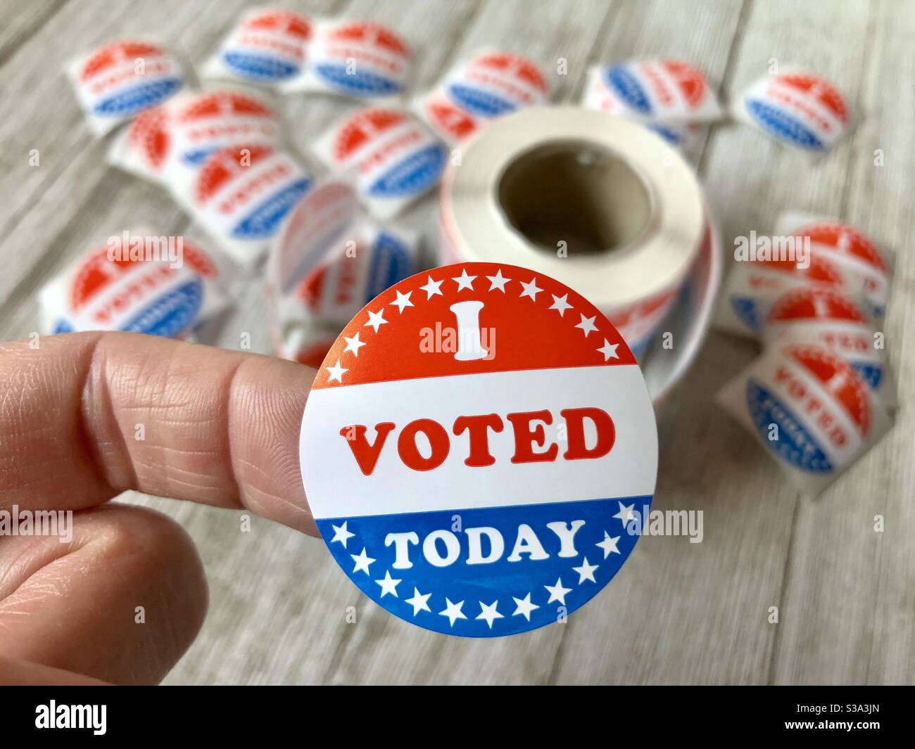 I voted sticker on a woman’s finger Stock Photo