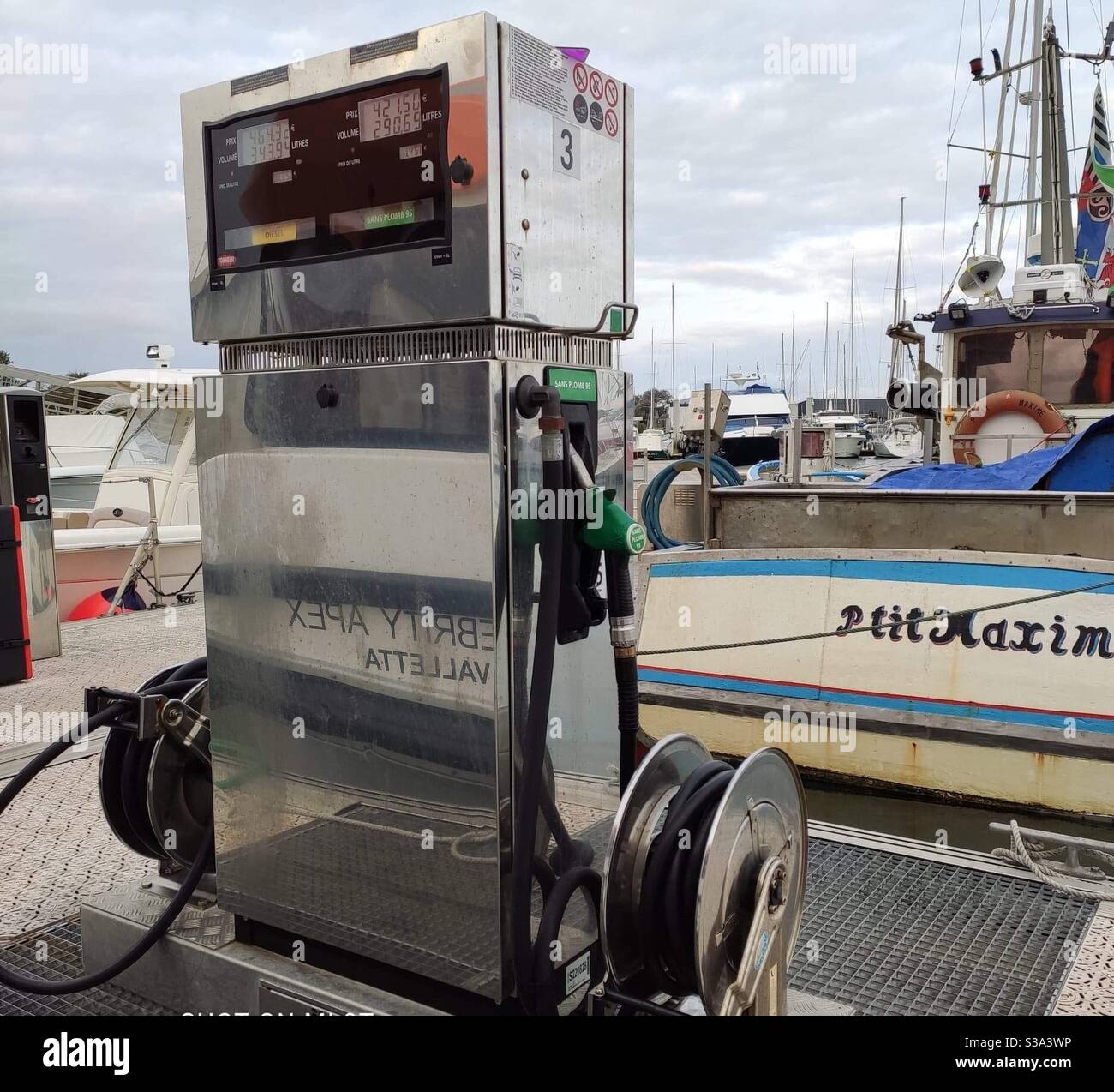 Gas station on the pier in Pornichet, France, with an old fishing boat