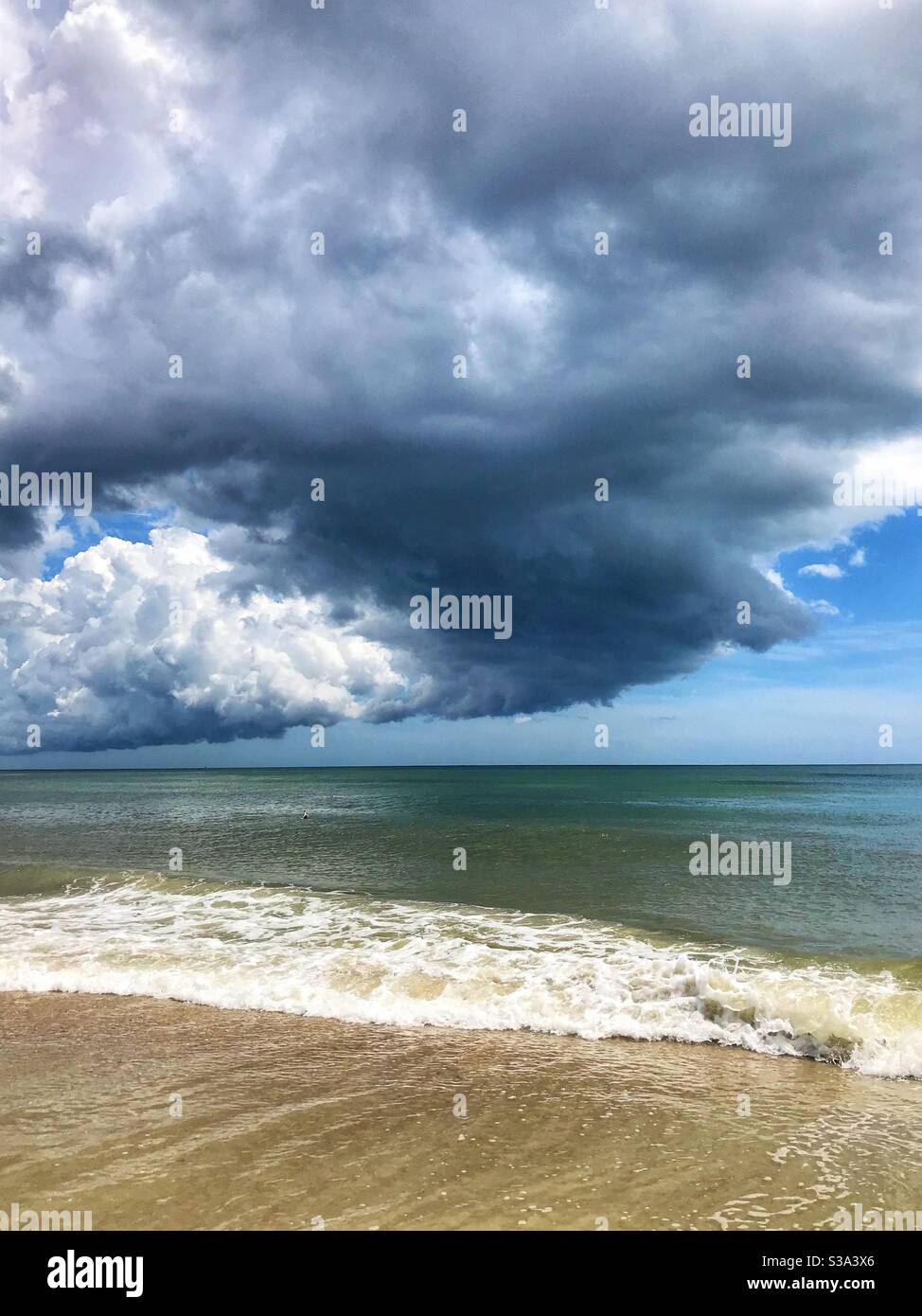 Summer thunderstorm rolling out over the ocean, Jacksonville Beach, Florida - Smartphone Captured Stock Image