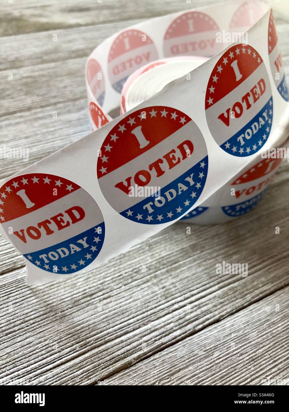 Roll of I voted stickers on a wooden table Stock Photo