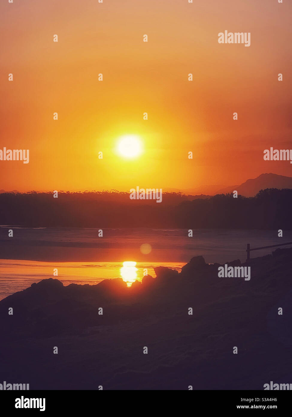 Sunset by the sea glowing glorious golden orange , sun reflected in the water - Smartphone Captured Stock Image