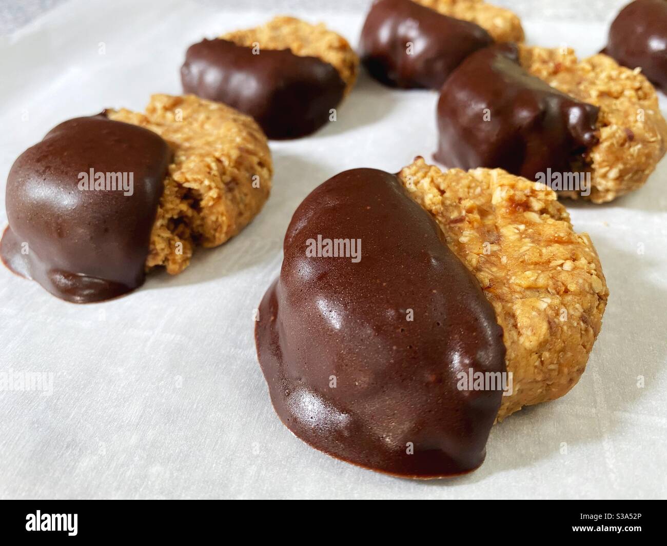 Vegan, no refined sugar, no bake peanut butter cookies dipped in chocolate. Stock Photo