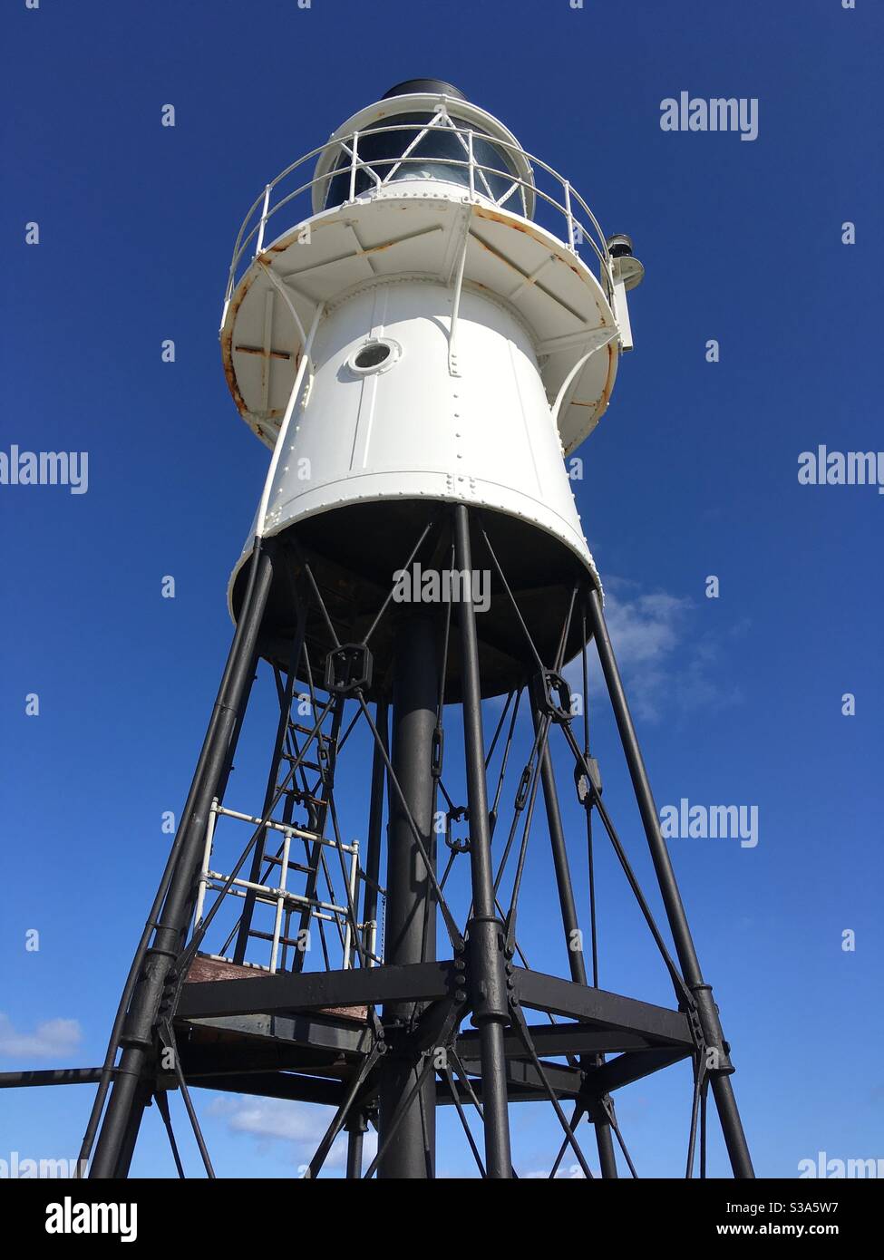 Lighthouse beacon against a blue sky - Smartphone Captured Stock Image