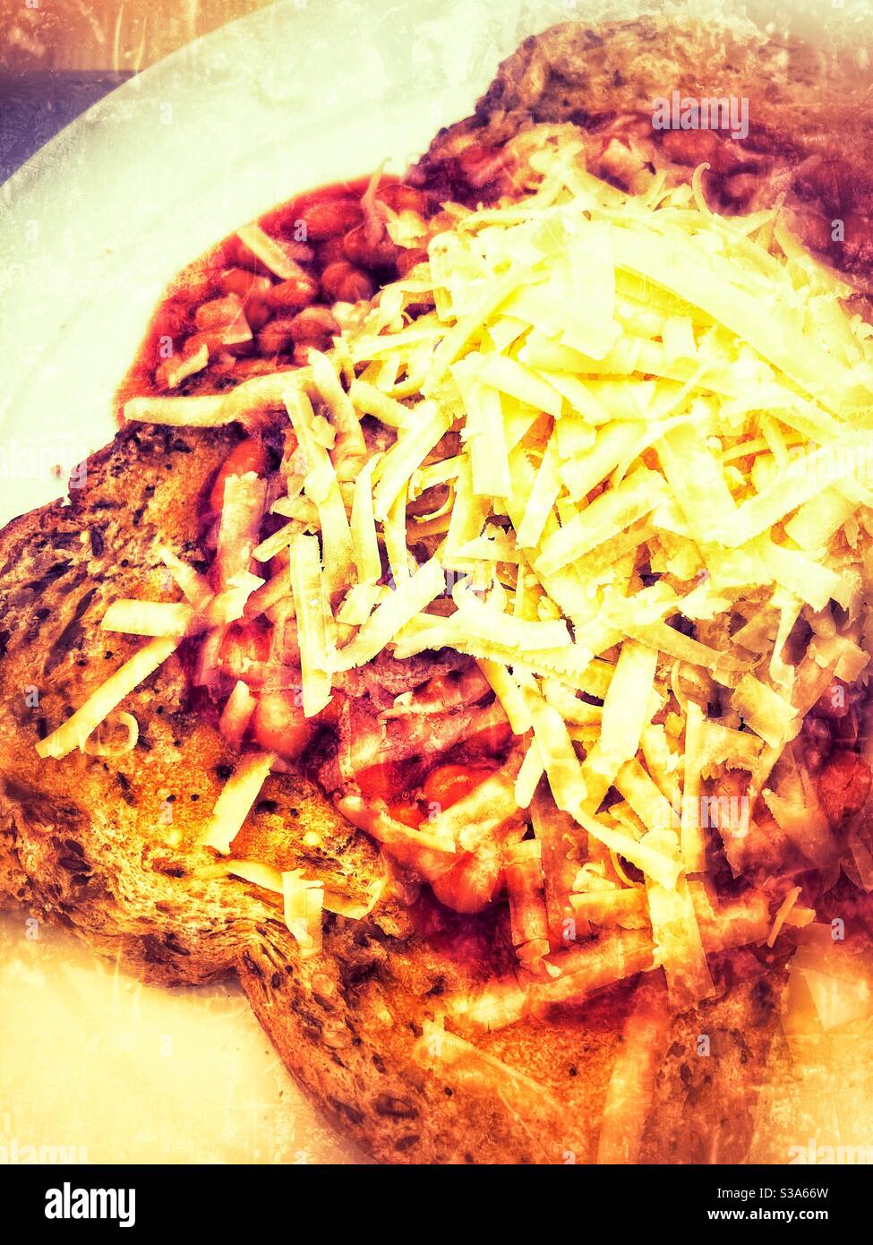 Baked beans on toast with grated cheddar cheese, grunge filter applied