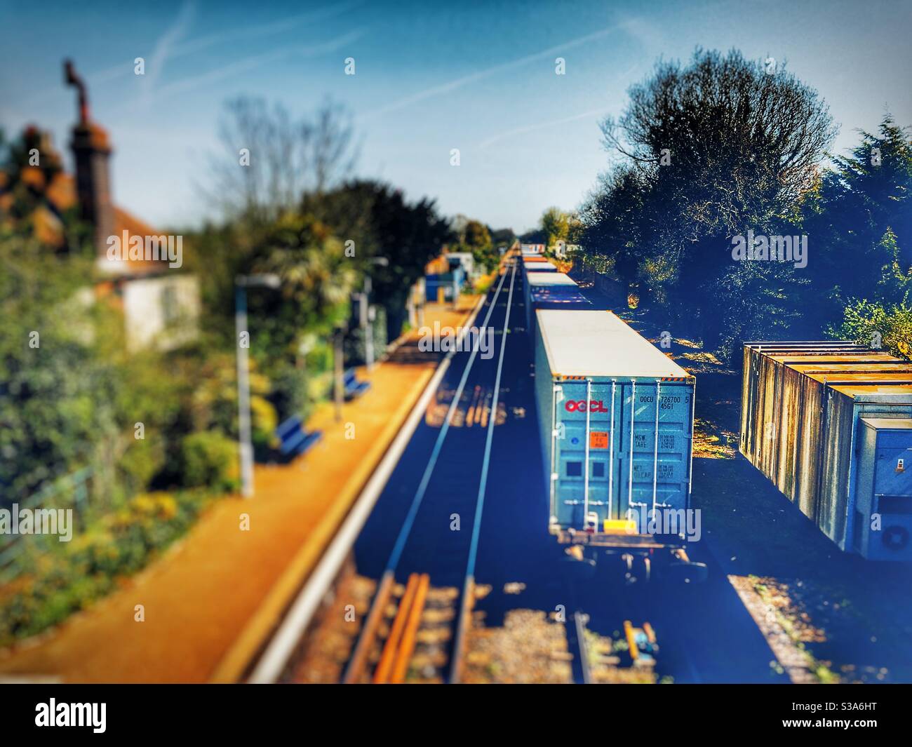 Freight train going through Trimley railway station on route to the port of Felixstowe, Suffolk, UK. - Smartphone Captured Stock Image