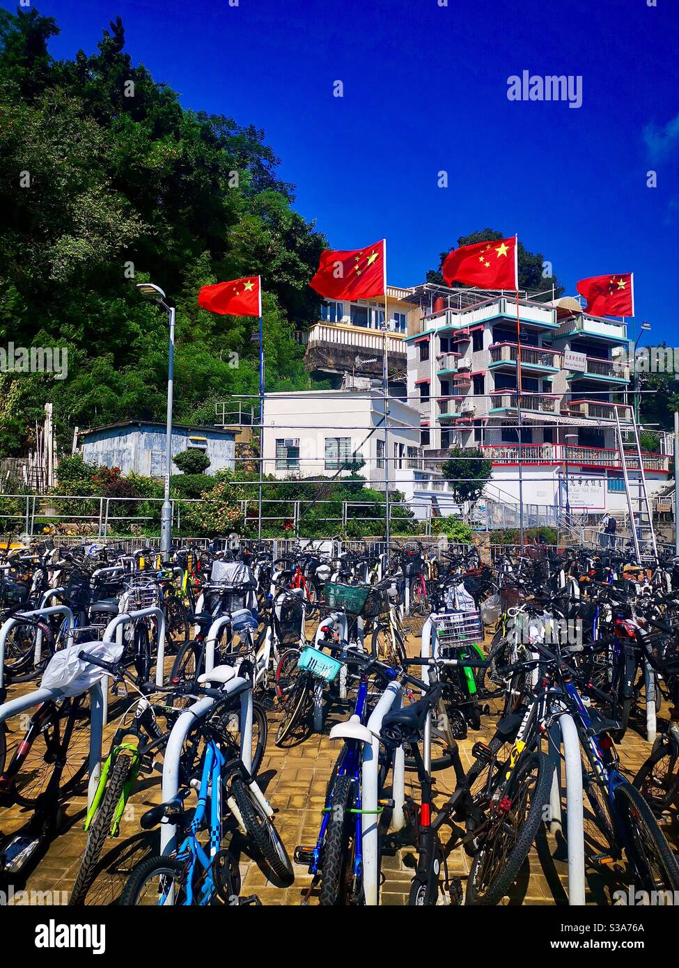 Chinese flags flying high in Lamma Island in Hong Kong during China’s national day celebrations. Stock Photo
