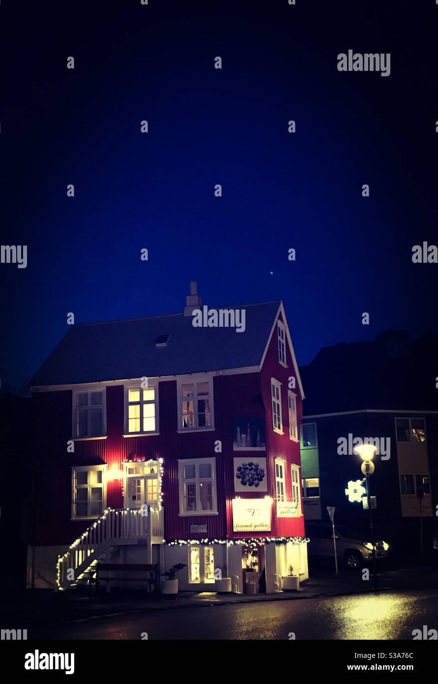 Festive Red House Illuminated with Christmas Lights in Downtown Reykjavik - Smartphone Captured Stock Image