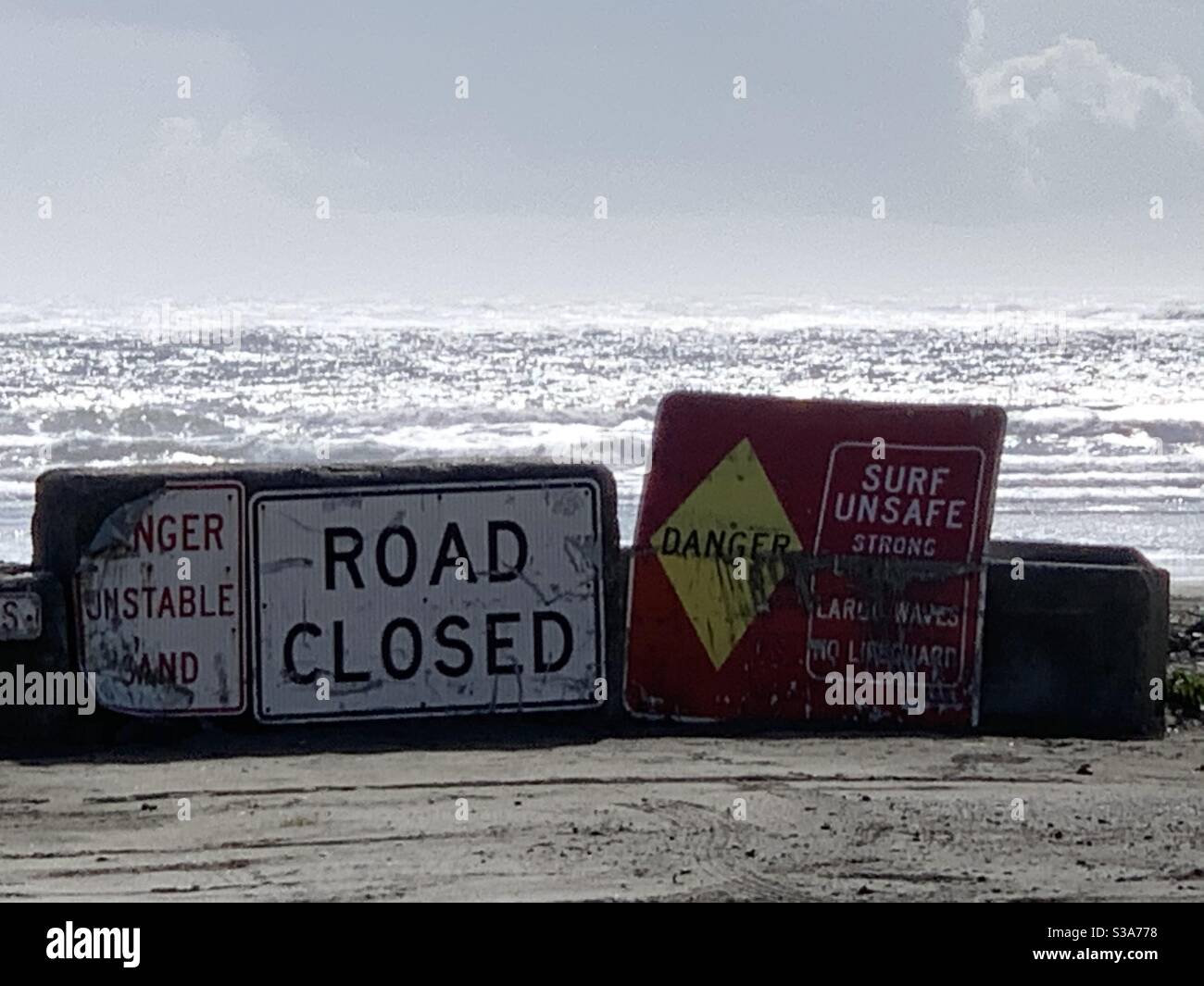 Road closed where the road has washed away into the Pacific Ocean at North Cove’s Wash Away Beach between Grayland &Tokeland WA. Lost are homes, a lighthouse, a schoolhouse & more. Stock Photo