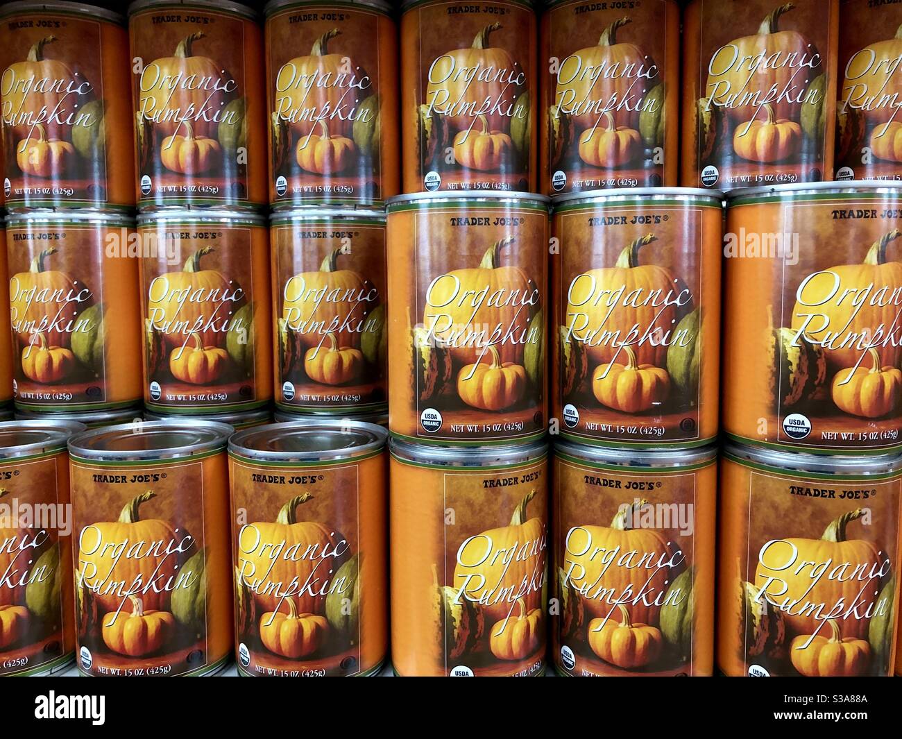 Cans of organic pumpkin on the shelves of Trader Joe’s supermarket, USA. - Smartphone Captured Stock Image