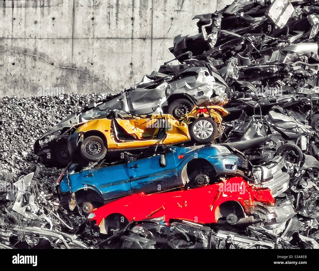 Crushed yellow, blue and red cars at scrapyard - Smartphone Captured Stock Image