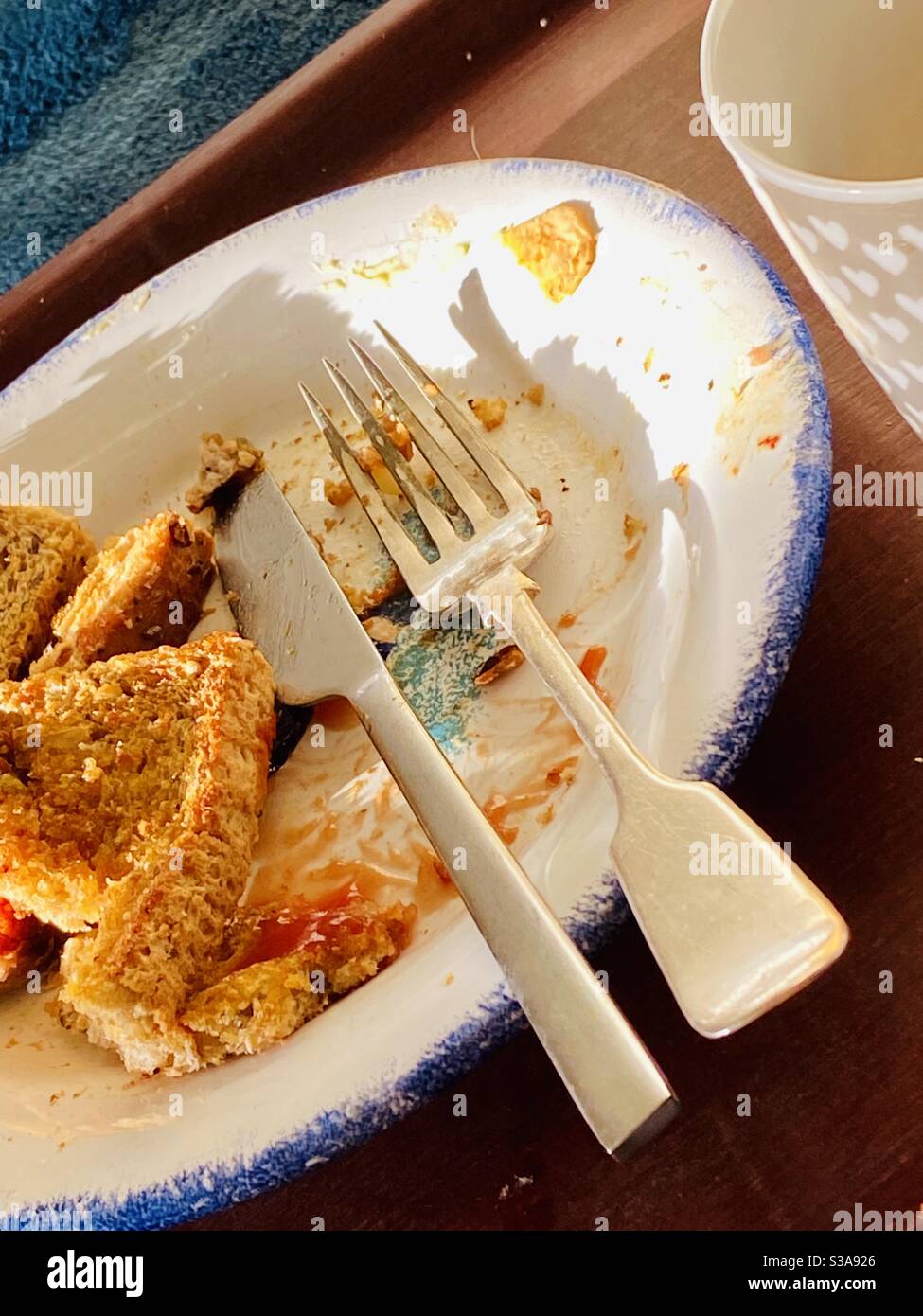 Breakfast plate knife and fork end of the meal - Smartphone Captured Stock Image