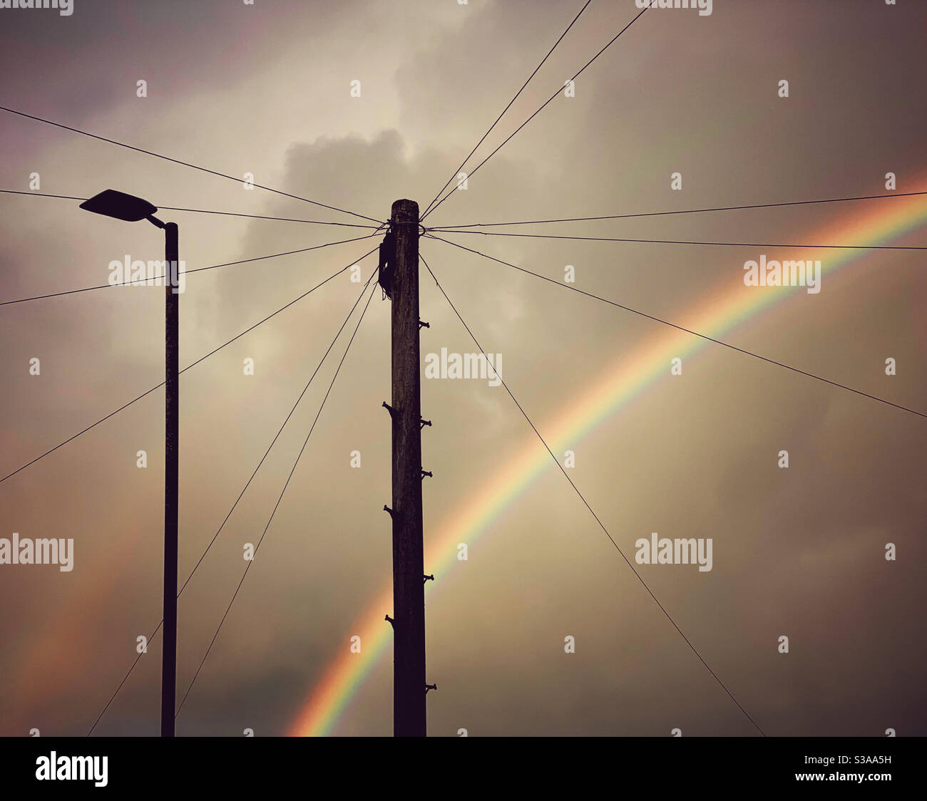 An impressive rainbow in an urban setting. The magic of light, diffraction and water droplets! Photo Credit - ©️ COLIN HOSKINS. - Smartphone Captured Stock Image