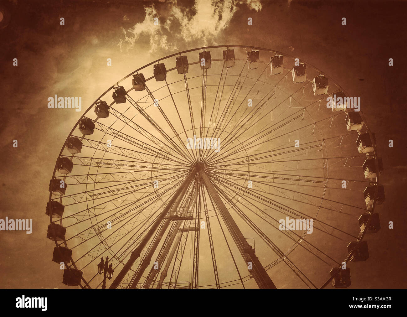 A retro effect image of an English Ferris Wheel. Even though you go round in circles - the views are usual spectacular! Photo Credit - ©️ COLIN HOSKINS. - Smartphone Captured Stock Image