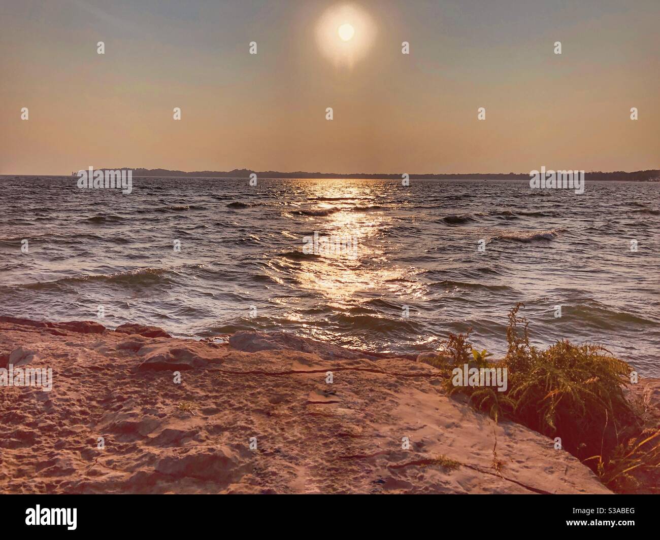 A glowing sunset over Lake Erie in Crystal Beach, Ontario, Canada. - Smartphone Captured Stock Image