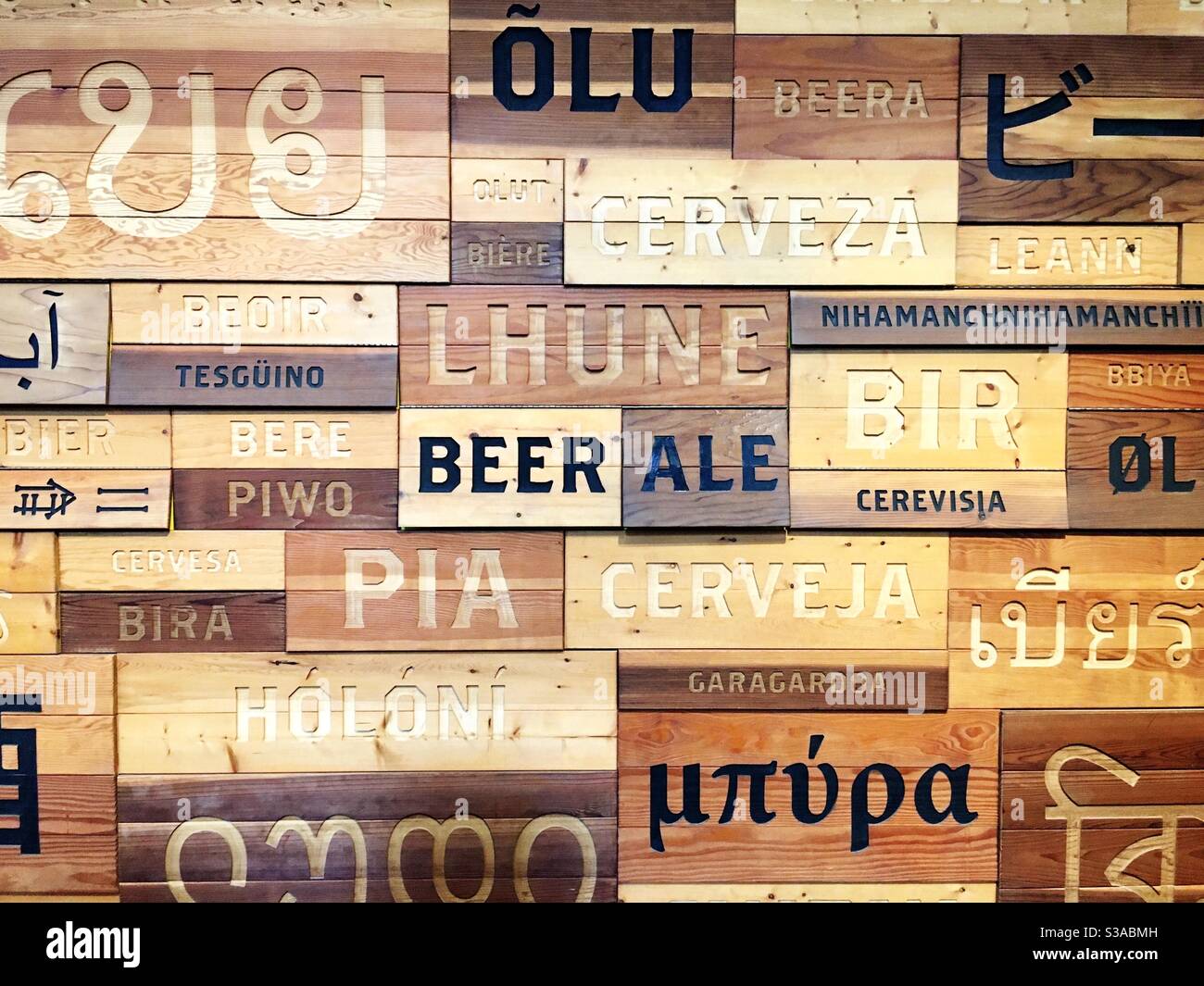 “Beer” in many languages on a wood wall Stock Photo Alamy
