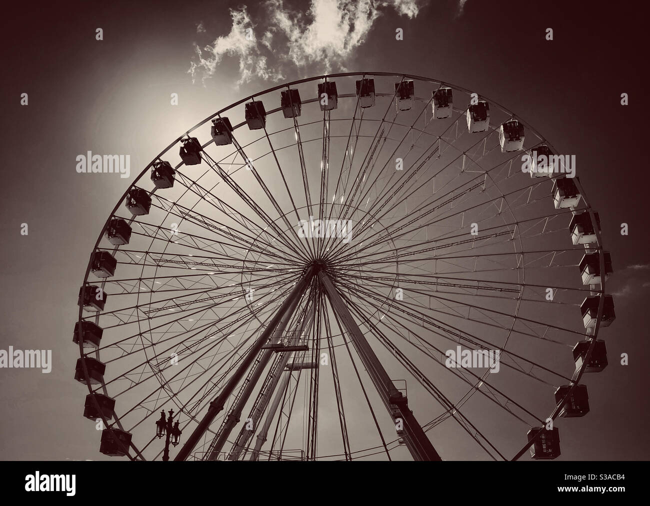 A moody image of a Ferris Wheel. All the fun of the fair! Photo Credit - ©️ COLIN HOSKINS. - Smartphone Captured Stock Image