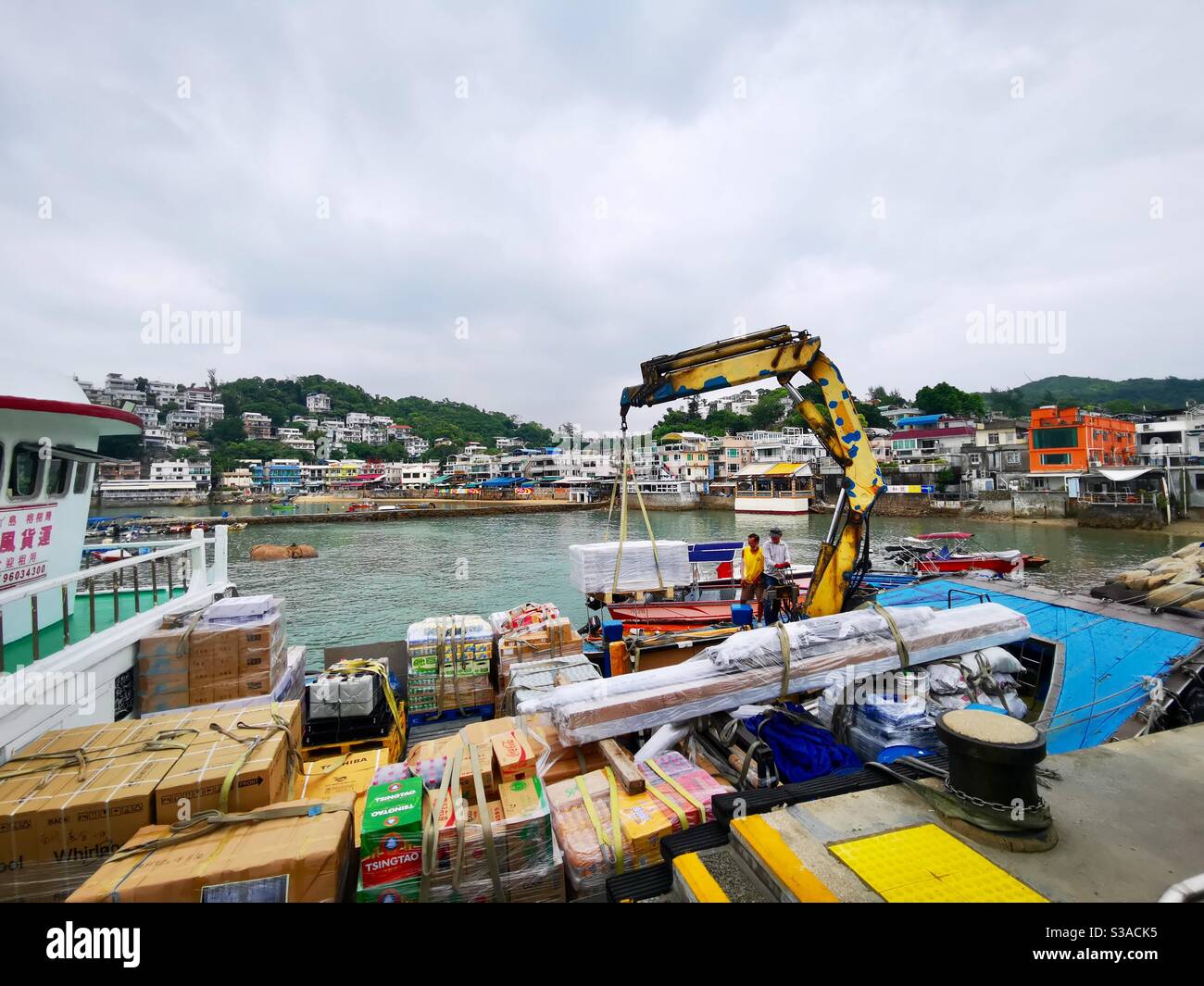 the Gaido ship unloading merchandise at the Yung shue wan pier in lamma island. - Smartphone Captured Stock Image