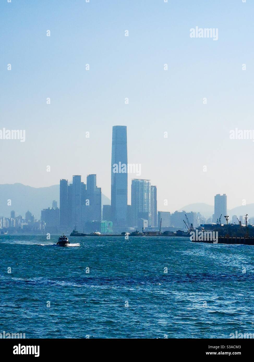 Morning views of the Icc tower and the Victoria harbour in Hong Kong. - Smartphone Captured Stock Image