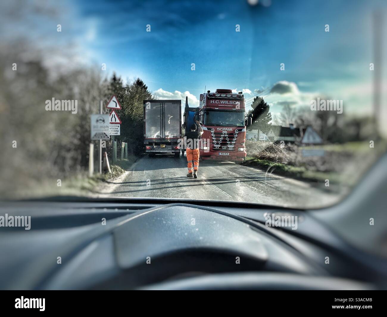 HGV lorries passing on a narrow country road, B1083, Shottisham, Suffolk, England. - Smartphone Captured Stock Image
