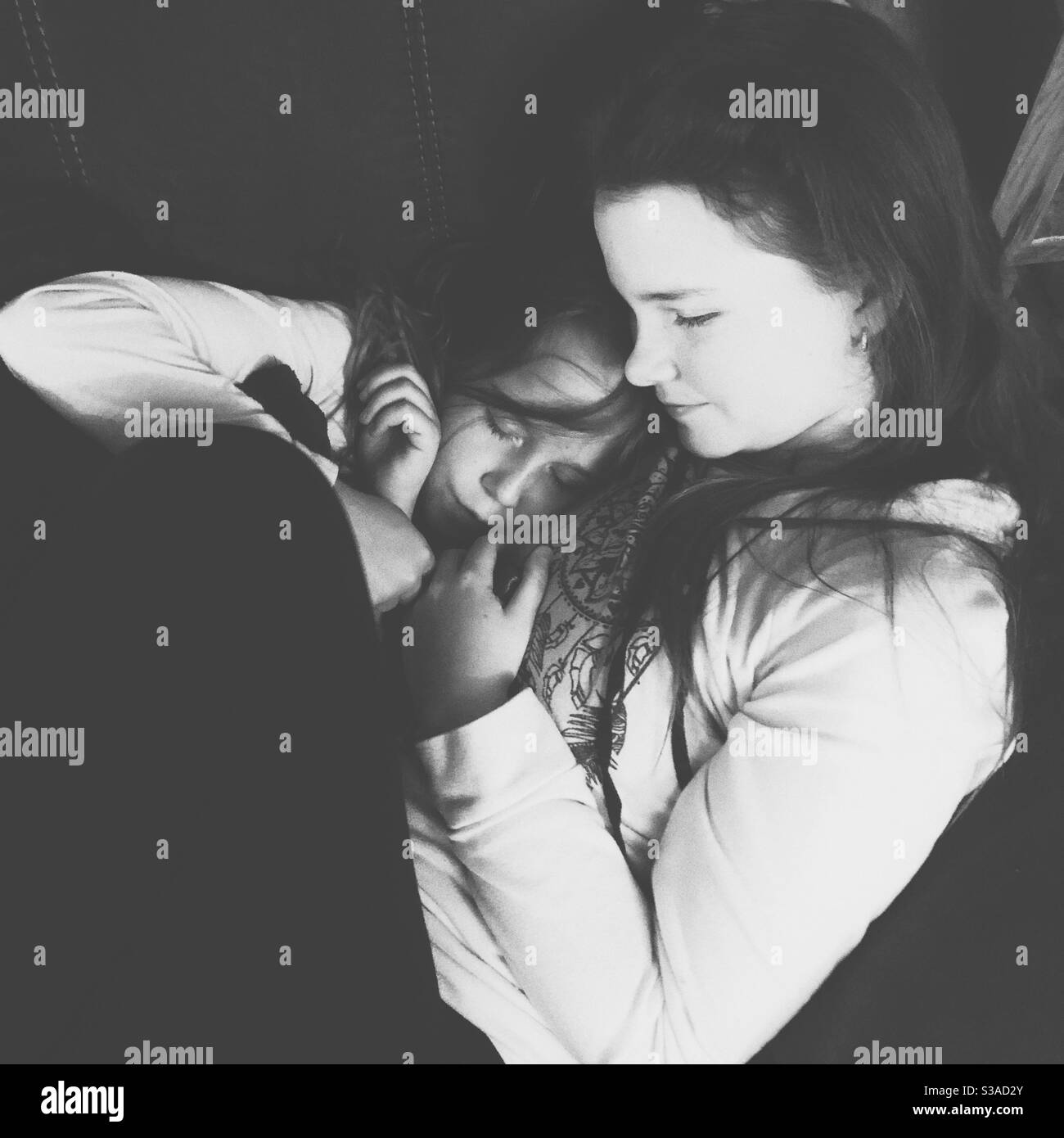 Two sisters cuddling - Smartphone Captured Stock Image