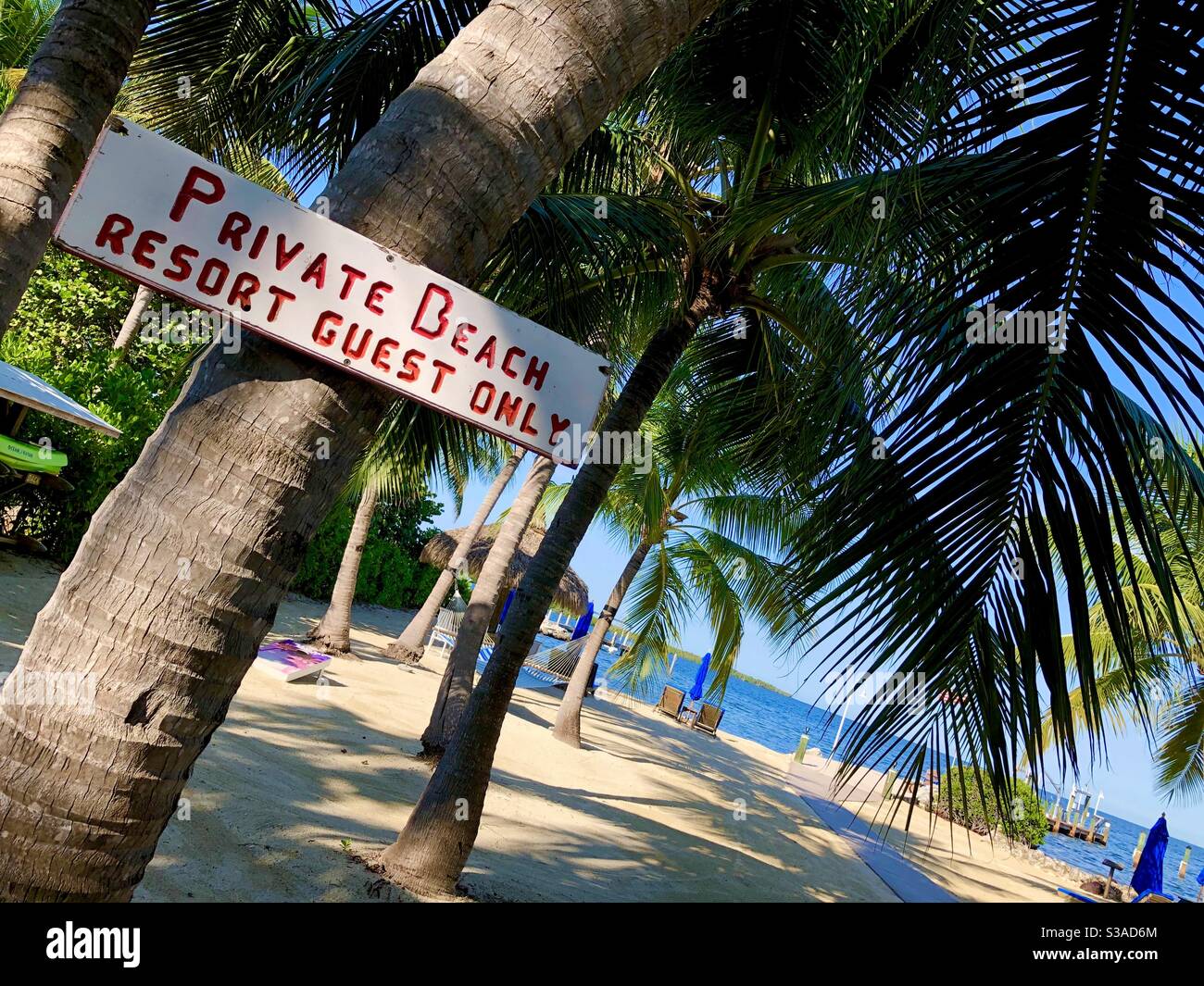 Sign at resort in Key Largo, Florida – “private beach resort guest only.” - Smartphone Captured Stock Image