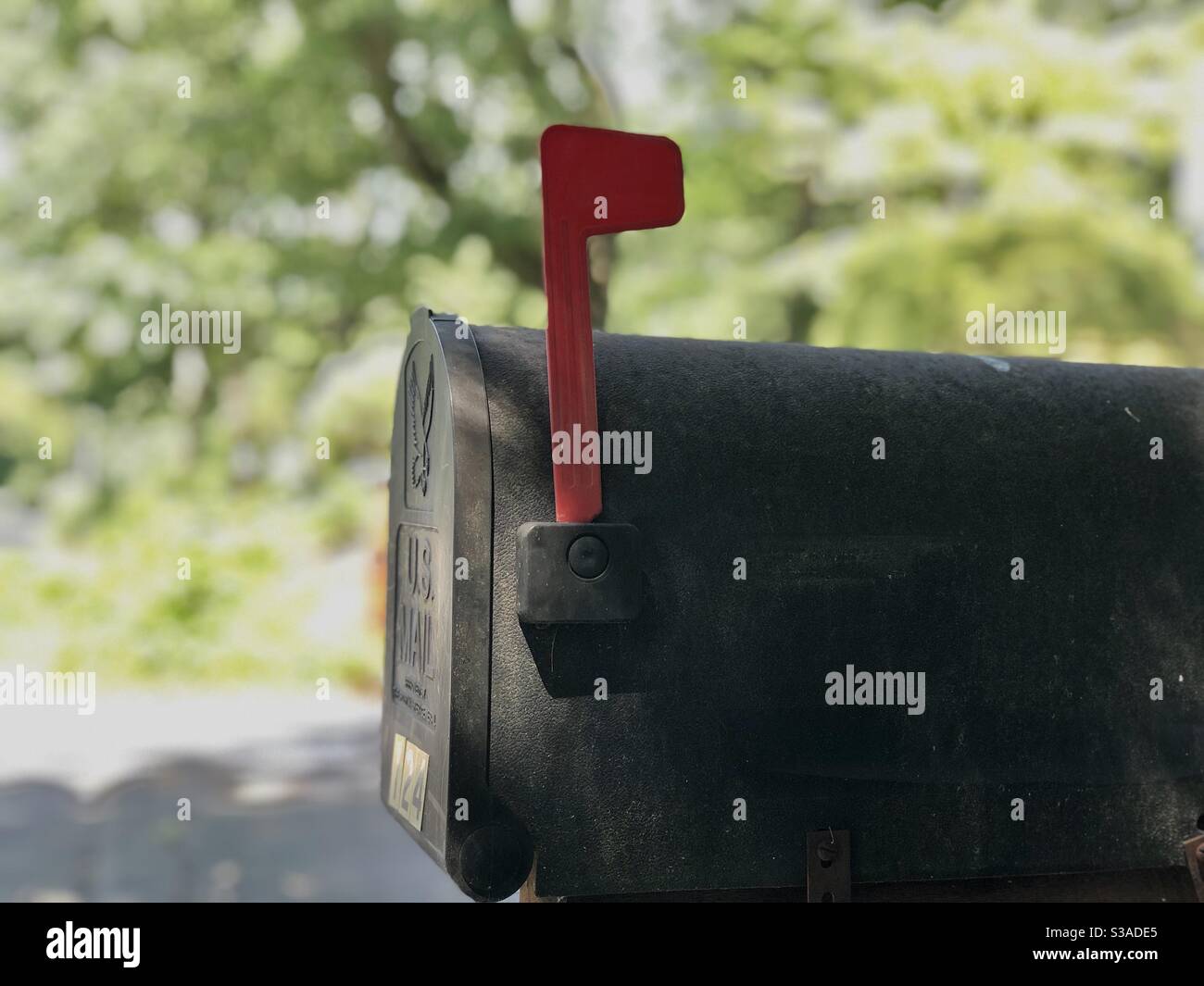 Residential mailbox, red flag up. Mailing absentee ballots in 2020 presidential election - Smartphone Captured Stock Image