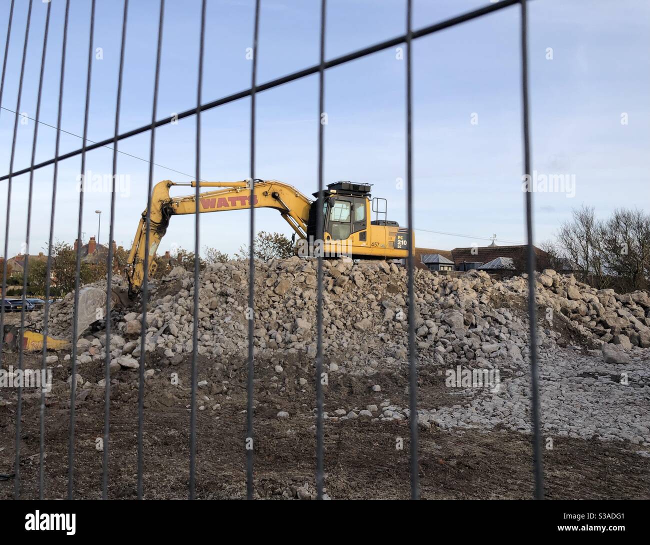 Digger clearing rubble of a demolished building Stock Photo