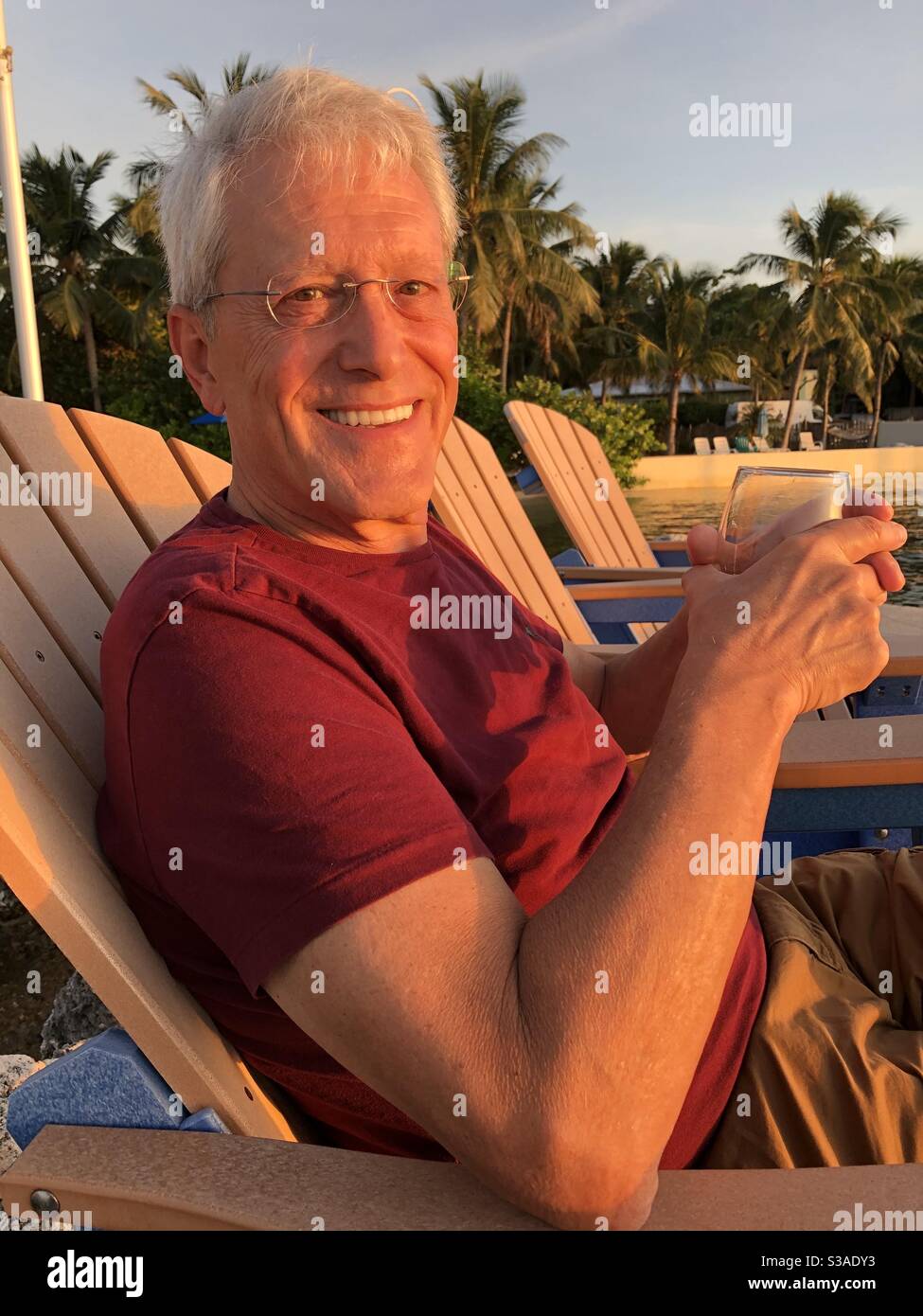 Senior man on vacation enjoying himself in the tropics. - Smartphone Captured Stock Image