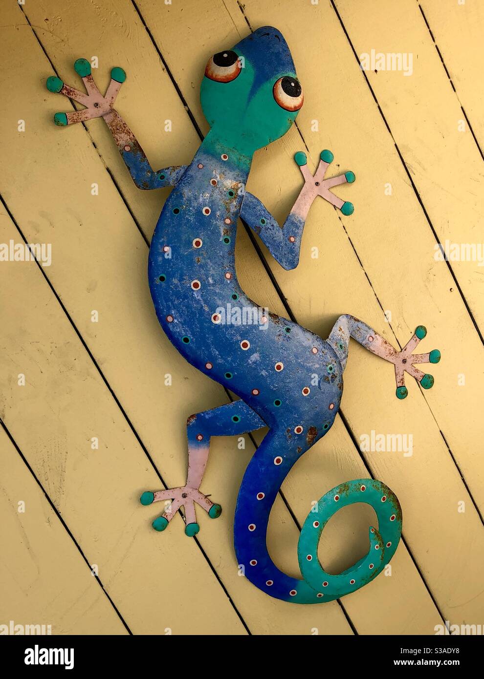 Gecko wall decor at tropical resort. - Smartphone Captured Stock Image